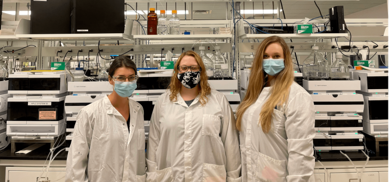 Three Kettering University alumnae post in a lab.