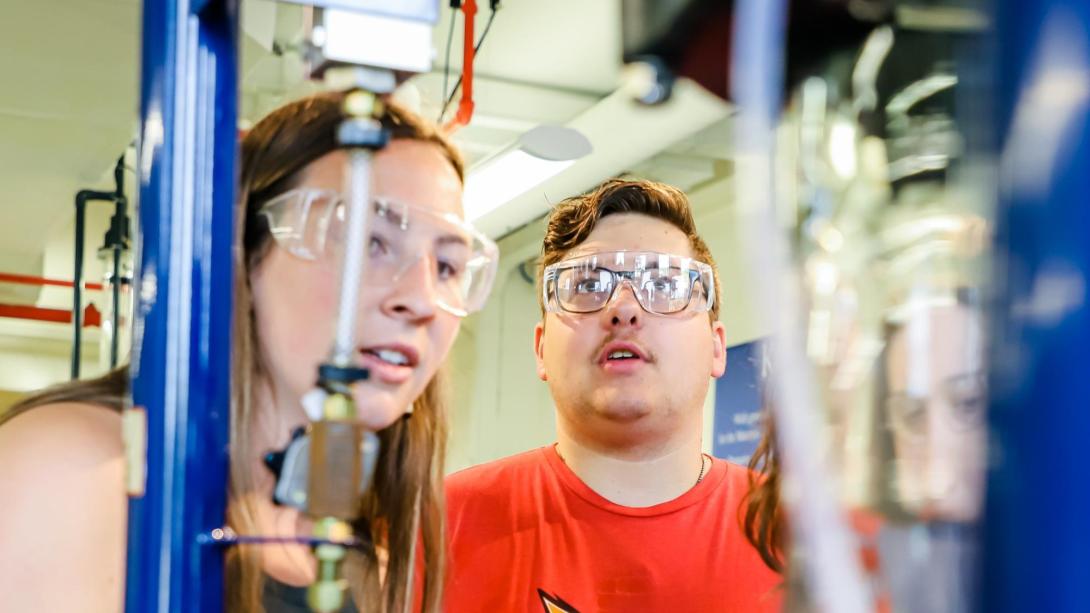 Two Chemical Engineering students in the filtration lab wearing goggles