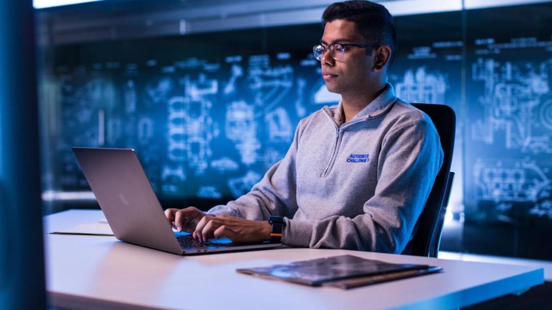 A student works on an assignment at his automotive co-op job.