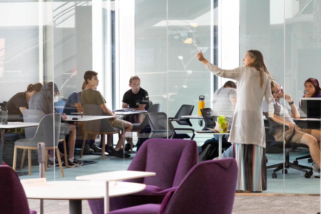 A faculty member teaches in front of a group of students in the DSpace Learning Commons