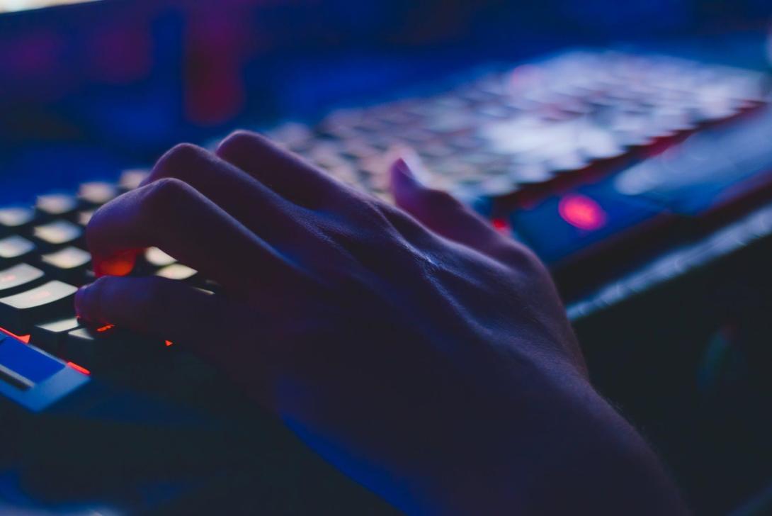 A hand typing on a keyboard