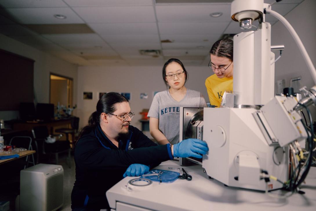 A Kettering professor and two students use an electron microscope