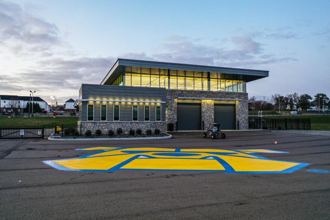 The Kettering GM Mobility Research Center building with a giant bulldog logo painted on the floor in front. 