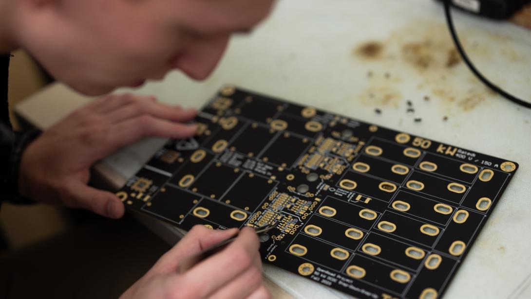 Student working on a circuit board in the Amped Lab