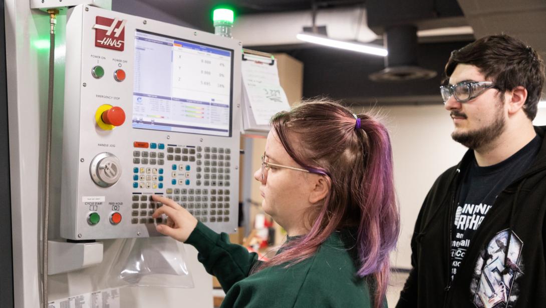 Two students working with equipment