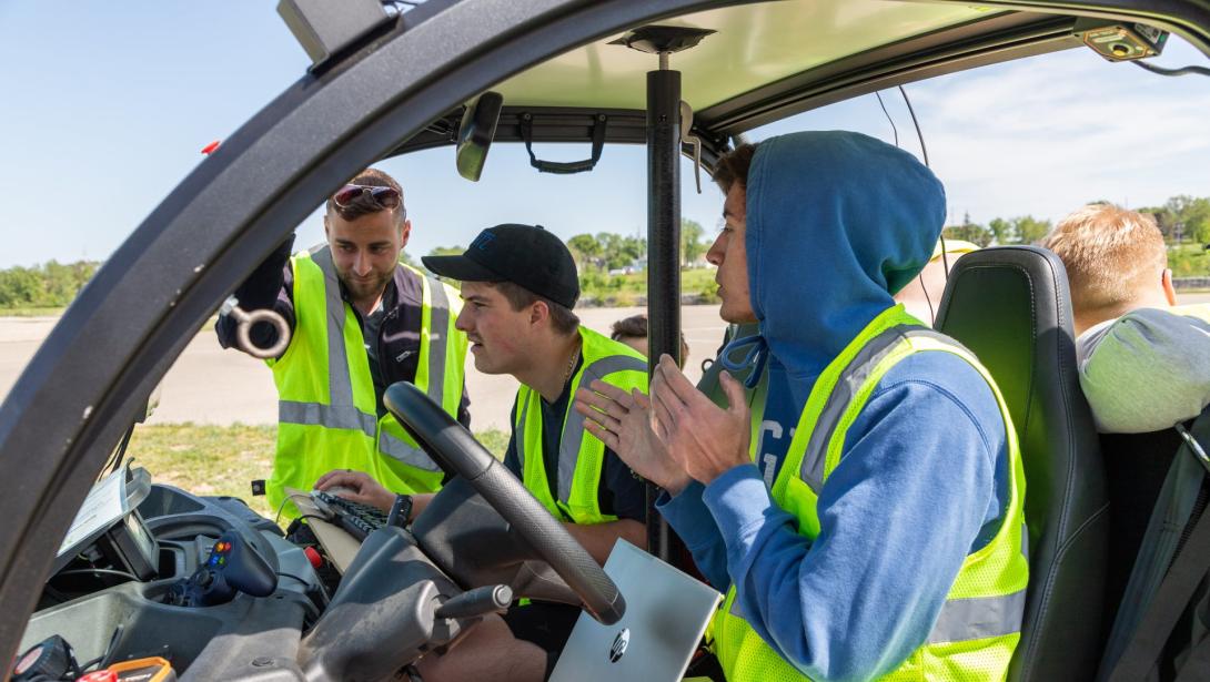 Students working in a model vehicle