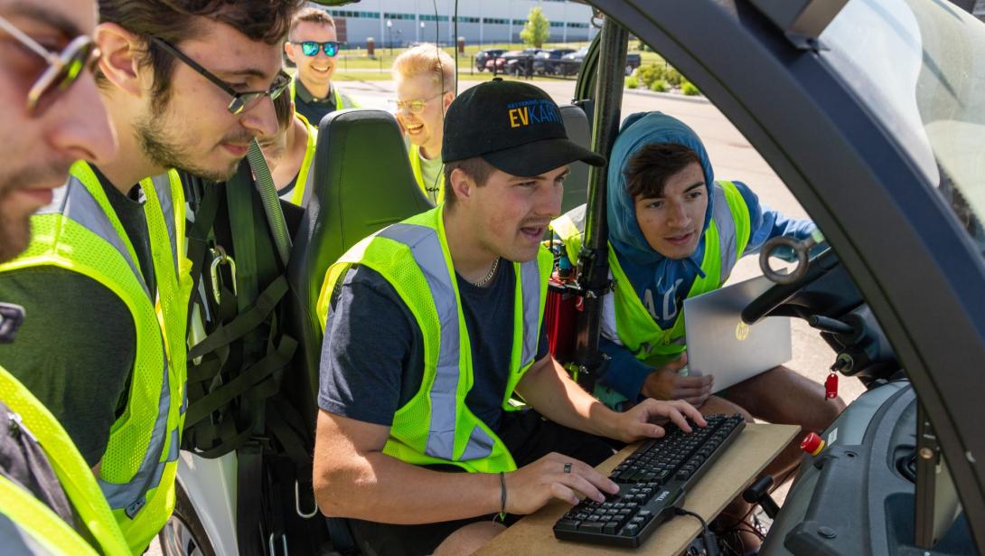 Students working in a model vehicle