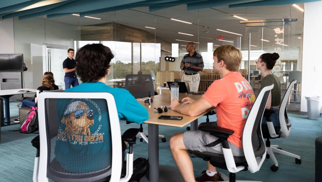 Business students sit around a table in the Learning Commons