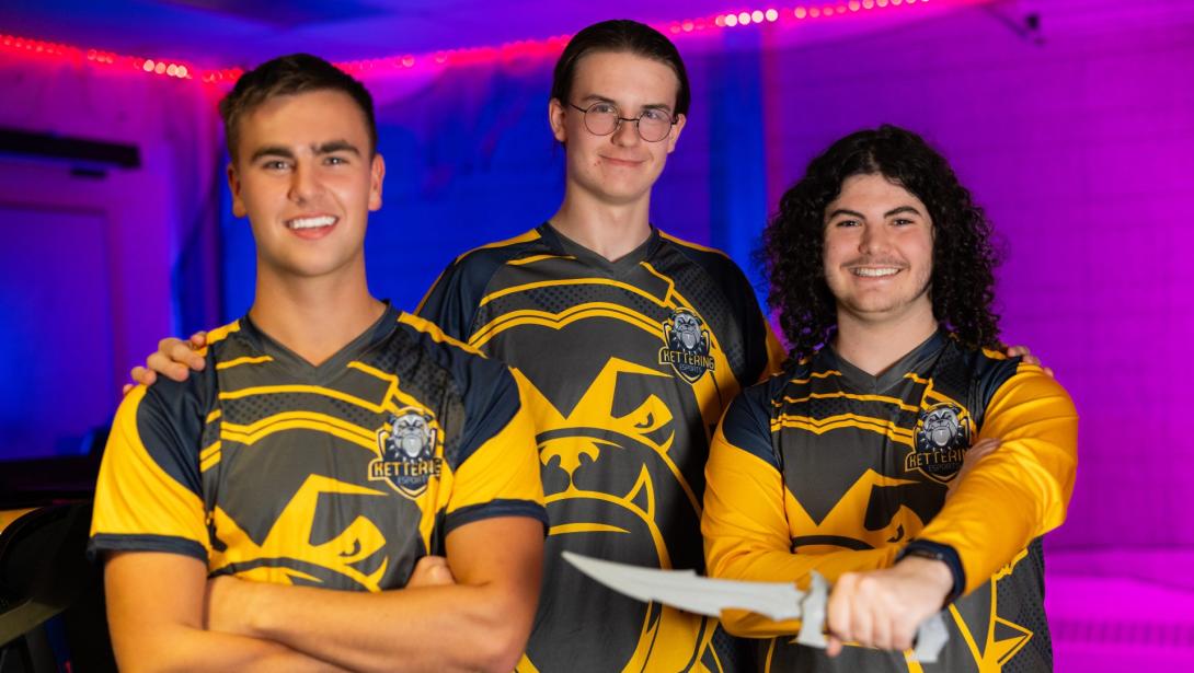 Three members of the esports team wearing jerseys