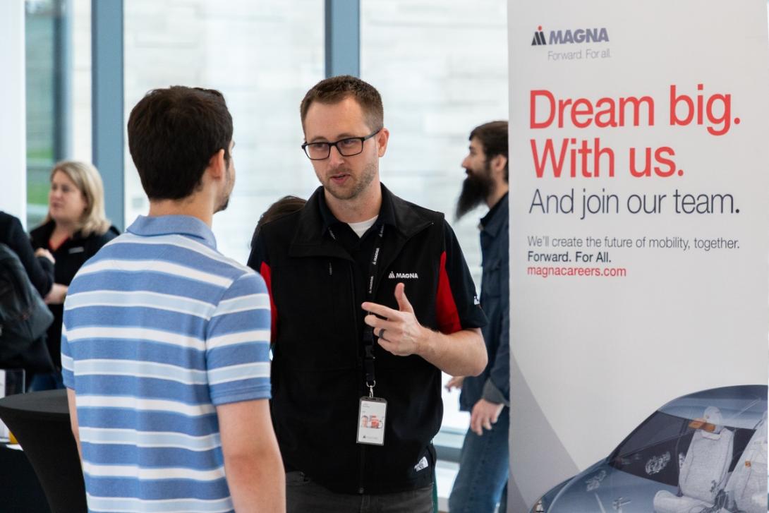 A student speaks with a prospective employer at a job fair