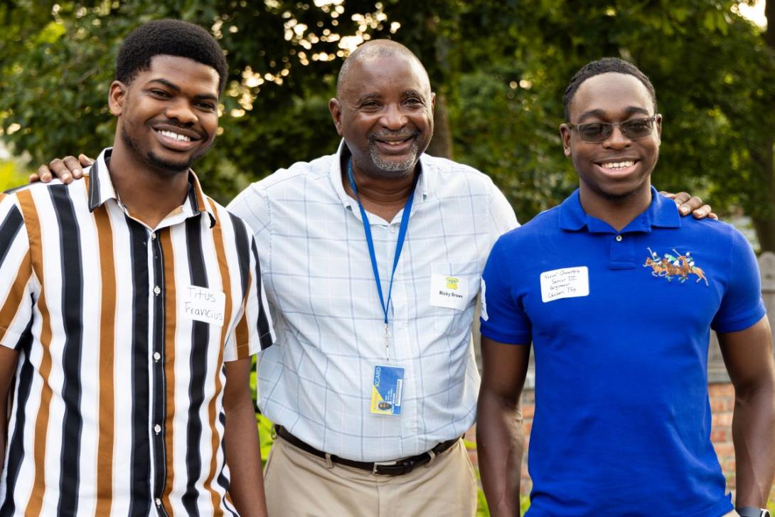 Ricky Brown, Kettering's director of multicultural student initiatives, smiles with students at Academically Interested Minds event