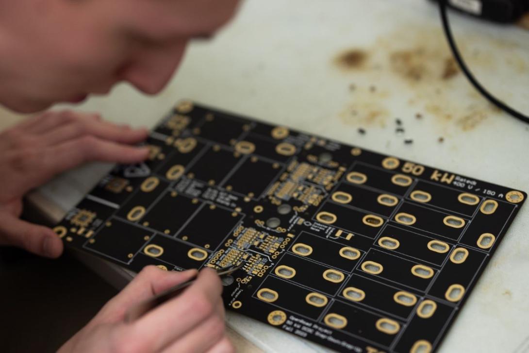 Student working on a circuit board in the Amped Lab