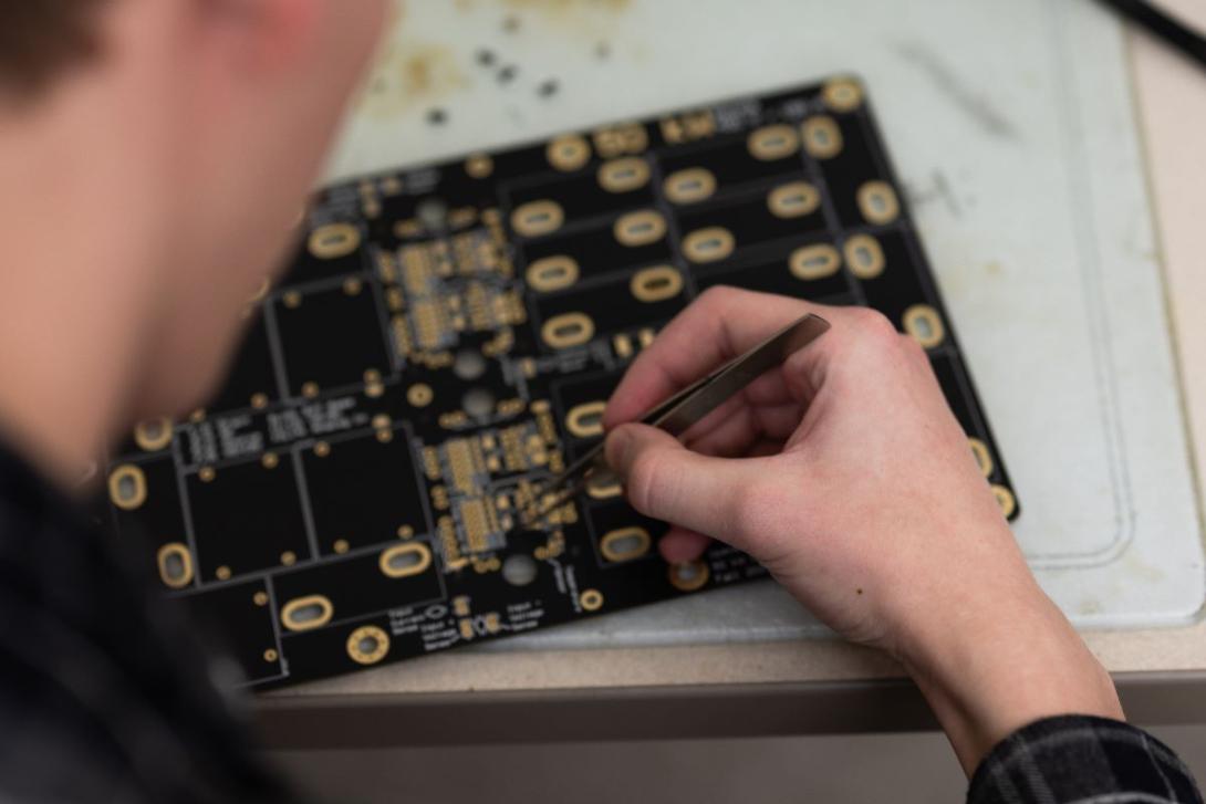 Student working on a circuit board in the Amped Lab