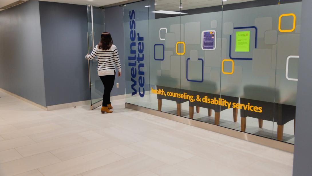 A student walks through the door of the Wellness Center on campus