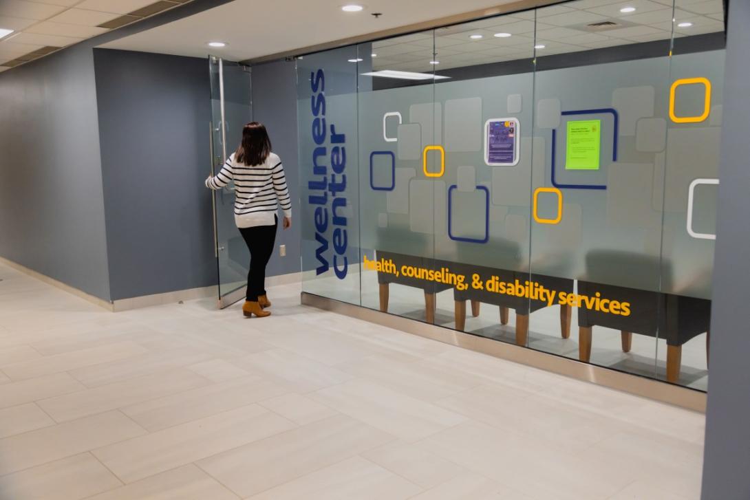 A student walks through the door of the Wellness Center on campus