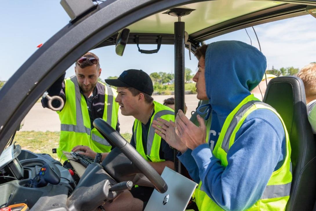 Students working in a model vehicle