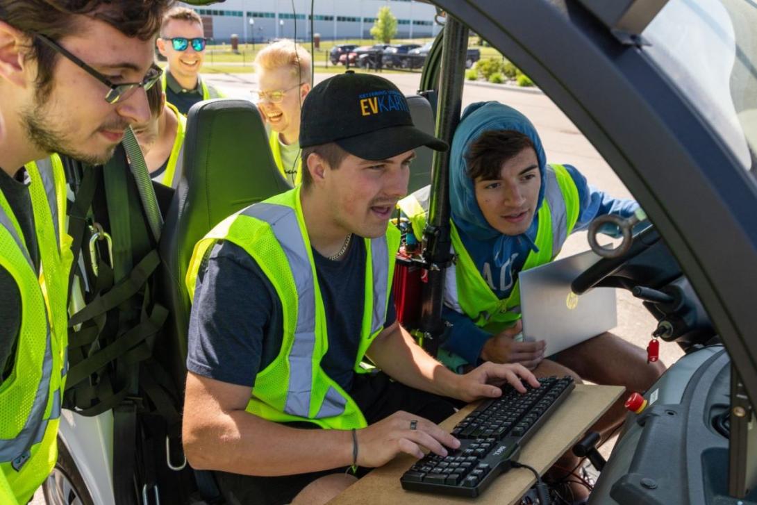 Students working in a model vehicle