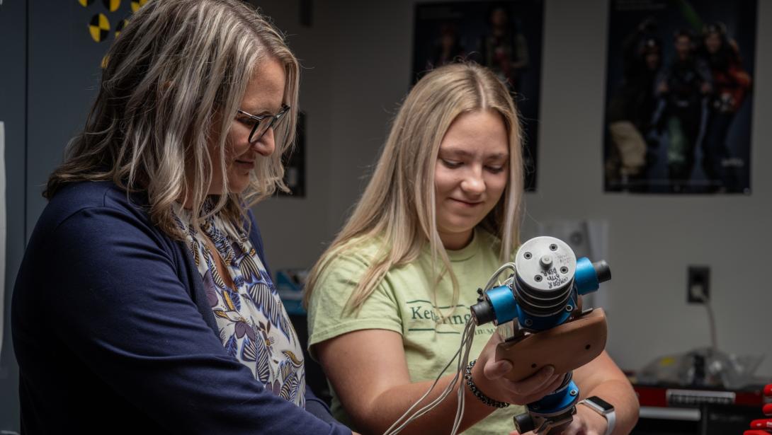 Two individuals work with equipment in the Crash Lab