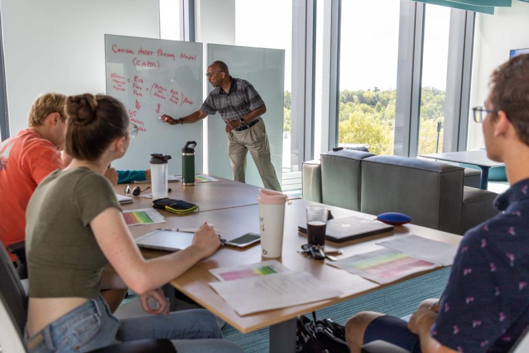 A Professor teaching a class of students in the Learning Commons