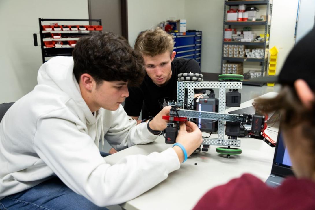 Students working to put together a small robotic vehicle