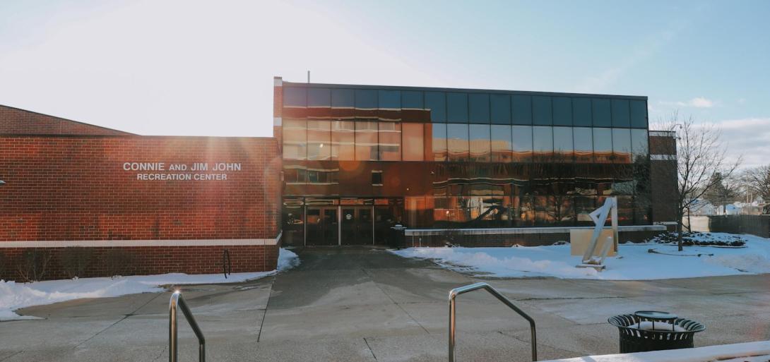 Exterior view of the Connie and Jim John Recreation Center at Kettering University on a sunny winter day.