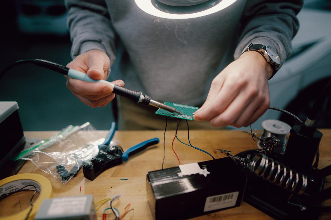 computer engineering student working on computer panel