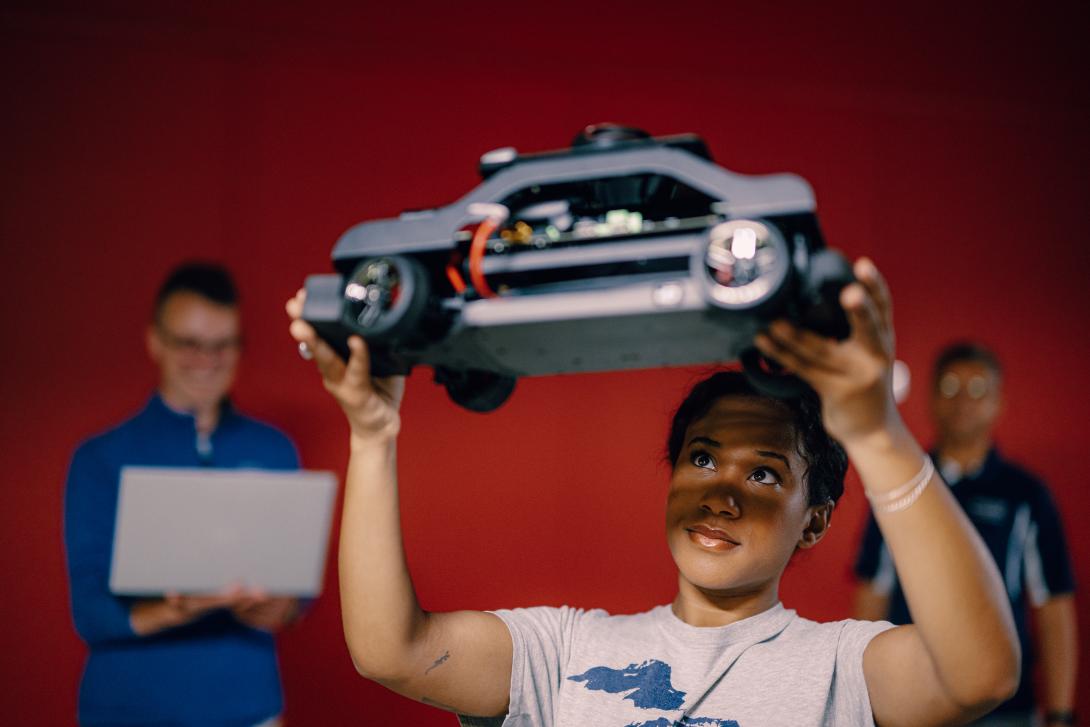 student in lab analyzing vehicle prototype