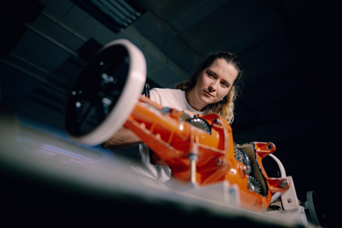 young lady examining motor 