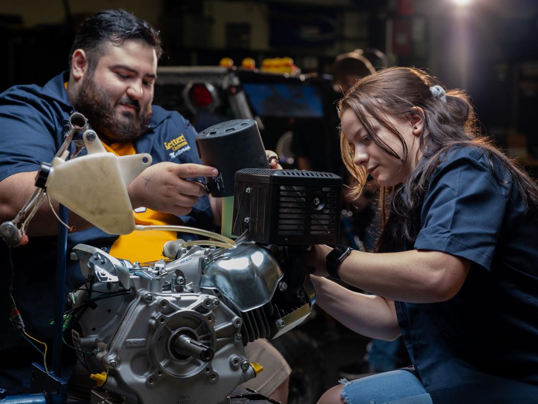 students working on engine in SAE garage