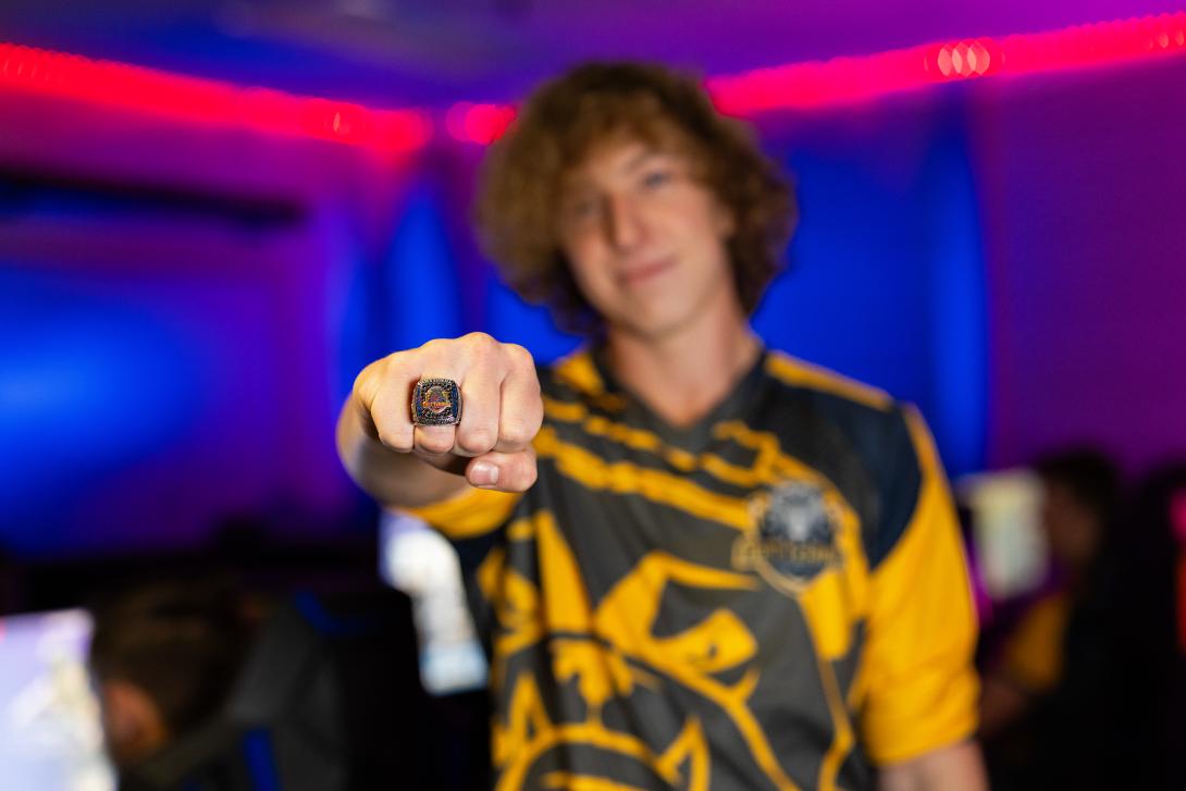 student showing esports championship ring