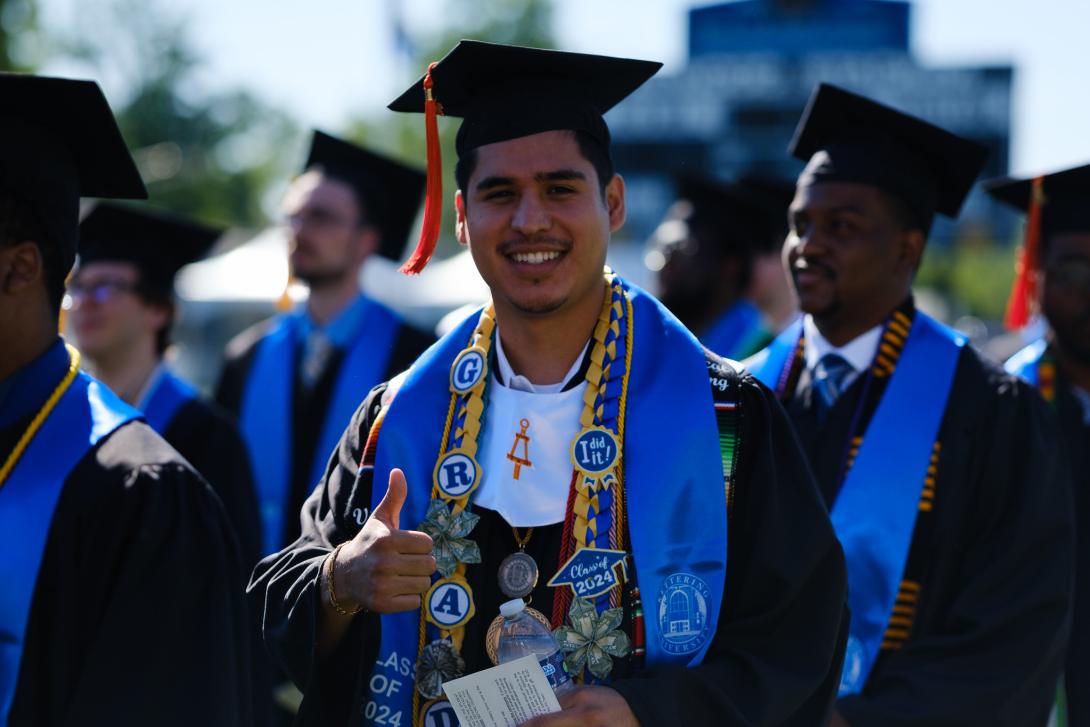 student giving thumbs up at commencement